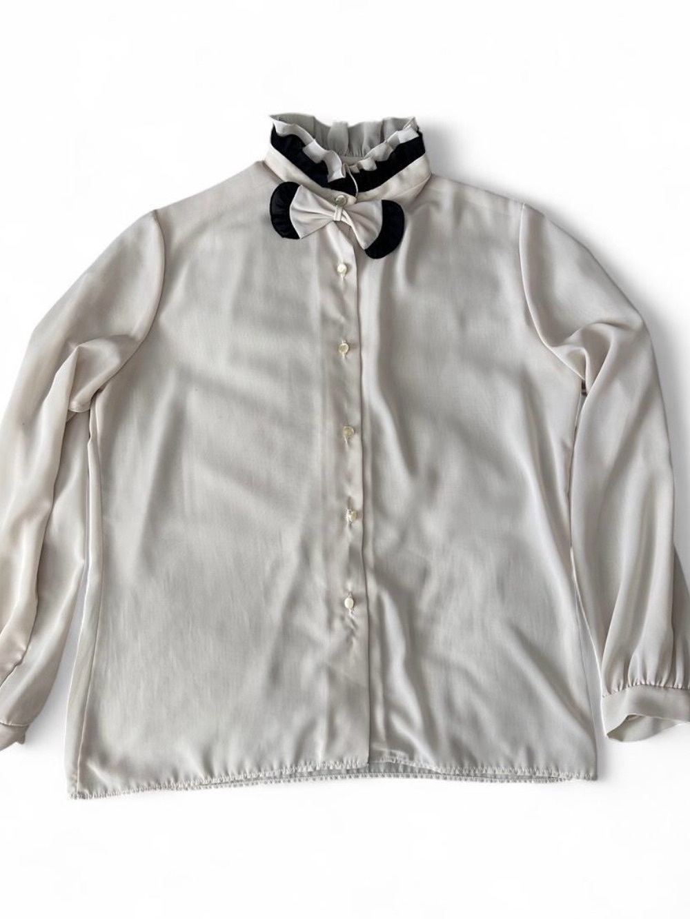 White blouse with black bow detail
